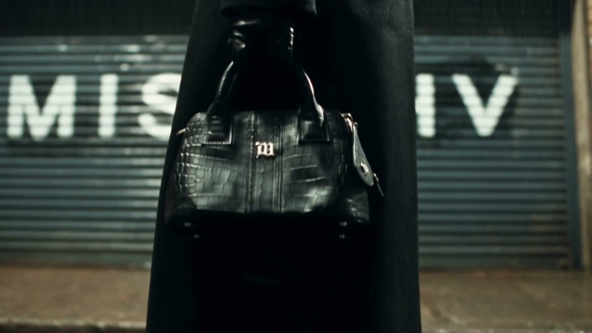 AI brand film still: a black crocodile-embossed leather bag
